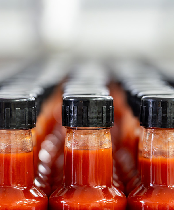 cookies being decorated with red icing in a bakery production line 3 delicious flavors